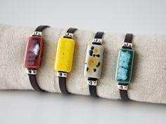 Colorful women's leather bracelet with rectangular ceramic and silver brass beads. Dark brown flat leather and ceramic bracelet in 4 colors with an original speckled effect (turquoise green, burgundy, yellow and beige). Cute bracelet with bright and vivid colors. Unique handmade contemporary boho style summer jewelry. Ideal gift for her, gift for mom, sister, daughter, friend... Important: Always measure your wrist circumference to ensure you have the correct size. Bracelet suitable for wrists from 14 to 16 cm. Outline. (5.5 to 6.3 inches) Care: It can get wet. It is recommended to hydrate the leather with grease or cream if necessary. ELABORATION Each ceramic piece is carefully modeled with white clay and hand painted with special ceramic glazes. Two firings of up to 1200 º C are necessar Everyday Handmade Leather Bracelet, Everyday Leather Bracelet Jewelry, Modern Adjustable Rectangular Jewelry, Modern Leather Jewelry Rectangular Shape, Modern Rectangular Leather Jewelry, Handmade Adjustable Rectangular Leather Bracelet, Adjustable Everyday Jewelry Bracelet, Minimalist Rectangular Leather Jewelry, Bohemian Rectangular Jewelry For Everyday