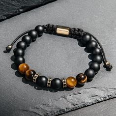 24/7 Customer Service Free United States Shipping 1 Year Warranty on All Products Adjustable Size Handmade with Care 8 mm Onyx Beads 8 mm Tiger Eye Beads Black Crystals Sometimes, whether in our work life or our relationships, it can feel like we’re walking a tight rope. Adopting the energy of Onyx let’s you breathe easier, giving you the balance, confidence and protection to take the next step. Tiger’s Eye helps you to see through a fresh set of eyes, so that you can gain clarity on situations that have become blurry or confusing. Tiger’s eye shifts your outlook so that you can gain a deeper understanding of yourself. Gold Beads Bracelet, Hamsa Bracelet, Lapis Lazuli Bracelet, Black Onyx Bracelet, Zodiac Bracelet, Red String Bracelet, Tiger Eye Bracelet, Gold Bead Bracelets, Onyx Bracelet