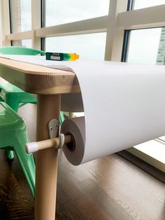 a close up of a roll of paper on a table with a window in the background