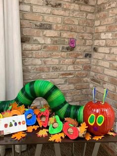 the very hungry caterpillar has been decorated with leaves and pumpkins for halloween