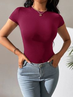 Introducing our Short Sleeve Slim Fit Bodysuit, the perfect addition to your wardrobe. Made from a soft and stretchy fabric, this bodysuit comes in four different colors. Featuring a classic round neckline and short sleeves, this bodysuit is perfect for any occasion. The solid pattern adds a touch of simplicity, making it easy to pair with your favorite pants, shorts, or skirts. Features: Style: Casual Pattern Type: Plain Type: Tee Neckline: Round Neck Sleeve Length: Short Sleeve Sleeve Type: Regular Sleeve Waist Line: Natural Fit Type: Slim Fit Fabric: High Stretch Material: Fabric Composition: 91% Polyester, 9% Elastane Body: Unlined Sheer: No Size Chart (Inches): Product Measurements Size US Bust Hip Size Length Shoulder Waist Size XS 2 29.1 27.6 27.8 12.2 24 S 4 30.7 29.1 28.3 12.6 25. Trendy Stretch Short Sleeve Bodysuit, Trendy Fitted Short Sleeve Crew Neck Bodysuit, Trendy Fitted Short Sleeve Bodysuit With Crew Neck, Trendy Fitted Crew Neck Short Sleeve Bodysuit, Trendy Stretch Short Sleeve Bodysuit With Scoop Neck, Trendy Stretch Short Sleeve Scoop Neck Bodysuit, Trendy Short Sleeve Scoop Neck Bodysuit, Trendy Fitted Short Sleeve Bodysuit, Trendy Stretch Crew Neck Short Sleeve Bodysuit