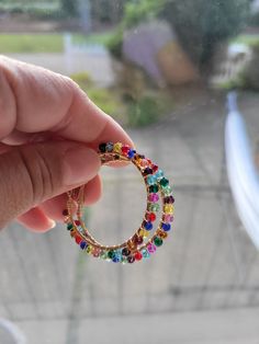 Multicolored crystal beads meticulously wire wrapped over gold hoop earrings. Doll Jewelry, Gold Hoop, Gold Hoop Earrings, Crystal Beads, Wire Wrapped, Doll Toys, Wire Wrapping, Doll Clothes, Etsy Earrings