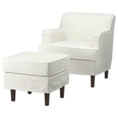 a white chair and footstool sitting next to each other