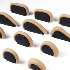 twelve pieces of black and brown wooden ear plugs