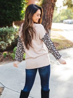 Get ready to elevate your wardrobe with the Lyric Top - the must-have addition this season! Embracing a traditional style with a trendy twist, this top is sure to draw attention with its understated animal print. Complete with a sophisticated criss-cross design, it's perfect for dressing up or down, no matter the occasion. Sizing Small 0-4 Medium 6-8 Large 10-12 XL 12-14 Model is 5'6" wearing size Small. Chic Leopard Print Winter Tops, Stretch Leopard Print Tops For Fall, Leopard Print Cotton Tops For Fall, Fall Leopard Print Cotton Tops, Maxi Skirt Dress, Graphic Apparel, Fall Accessories, Knee Length Dresses, Knee Length Skirt