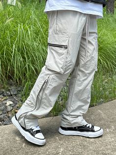 Editor's NoteCLACO's Nylon Side Zipper Cargo Pants are made out of nylon 100% fabric that has a subtle glow and light weight. With the side zippers extending up to up to the knees that makes the fit wider, you can style it in various ways. It has adjustable string on the waistband for comfortable wear. You can style it with various items for casual, relaxed, and trendy look during various seasons. - Adjustable waistband with string- Side zippers- Side cargo pockets- Adjustable silhouetteMeasurements (in.)M/L- Waist: 14.17 in / 14.96 in- Thigh: 12.60 in / 13.39 in- Rise: 12.60 in / 12.99 in- Hem: 8.27 in / 8.66 in- Length: 40.94 in / 41.73 inModel info: Height 5'11, Weight 169 lbs, Wearing size LComposition & Care- Nylon 100%- Refer to care labelDesigner- by CLACO Outdoor Cargo Pants With Zip Fly, Utility Parachute Pants With Zip Fly For Outdoor, Casual Bottoms With Zipper Closure For Outdoor Activities, Streetwear Pants With Zipper Closure, Full Length Pants With Zipper For Streetwear, Outdoor Techwear Pants With Zip Fly, Techwear Pants With Zip Fly For Outdoor, Techwear Cargo Pants For Outdoor With Zip Fly, Nylon Cargo Pants With Zip Fly For Outdoor