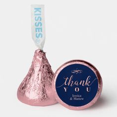 a blue and white thank you sticker next to a pink foiled hershey