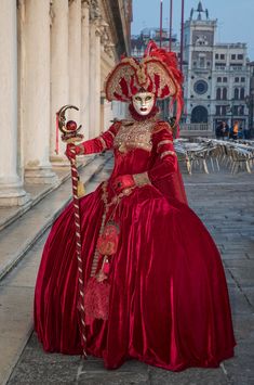 This striking clear image of a female participant in the Venice Carnival is posing for the camera to reveal her beautiful eyes inside the ornate, hand painted traditional mask.  Venice Carnival happens once a year before Easter and lasts two weeks. I have photographed this unique event twice so far and I want to return to do it again. Venice is both classic and romantic and the variance in Venetian costumes makes each carnival unique.  People from all over the world come to attend and most participate even if it involves wearing only a small mask.  The costumes cost in the thousands of dollars and on some nights, large balls are filled with costumed revelers who are donned in glorious fabric, vintage dress shoes, hand painted masks and elaborate wigs. As a photographer, I am constantly see Artistic Red Masks And Prosthetics For Costume Party, Artistic Red Masks And Prosthetics For Costume, Red Costume Masks For Festivals, Red Masks And Prosthetics For Costume Festivals, Red Masks And Prosthetics For Festivals, Artistic Red Masks And Prosthetics For Festivals, Traditional Masquerade Mask For Carnival, Traditional Red Masquerade Mask For Carnival, Traditional Red Costume Masks And Prosthetics