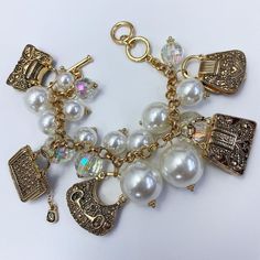 Pearl charm bracelet, allow 2-3 business days for delivery. Gold Metal Charm Bracelet As Fashion Accessory, Gold Metal Charm Bracelet Fashion Accessory, Elegant Adjustable Charms Jewelry, Everyday Charms Bracelet, Elegant Charm Bracelet With Removable Charms, Pearl Charm Metal Bracelet, Pearl Charm Bracelet In Metal, Elegant Beaded Metal Bracelets With Pearl Charm, Jewelry Making Bracelet With Removable Charms