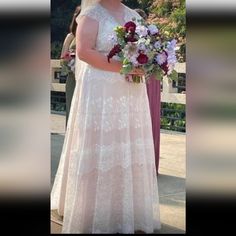 a woman in a wedding dress holding a bouquet