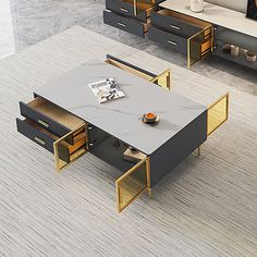 two tables with open drawers on each side in a living room, one is black and the other is gold