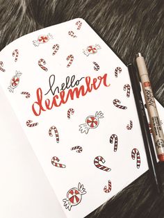 a notebook with the words hello december written on it