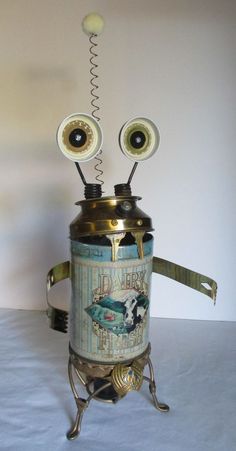 an old fashioned coffee pot with two eyes on it