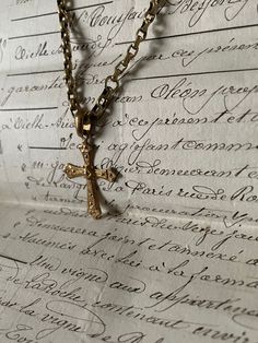 Handmade gold chain necklace with an ornate antique Turkish crucifix pendant. The crucifix is antique, the chain is also antique and has no fastening due to the long length. Handmade item incorporating antique elements.  This is a delicate piece and should not be exposed to perfumes or harsh chemicals.  Unique and one of a kind! I can gift wrap this also. Vintage Cross Chain Jewelry, Yellow Gold Brass Cross Pendant Necklace, Yellow Gold Brass Necklace With Cross Pendant, Vintage Engraved Cross Necklace Gift, Gold Figaro Chain Cross Necklace, Gold Cross Figaro Chain Necklace, Victorian Gold Necklace With Figaro Chain, Gold Figaro Chain Necklace With Cross Shape, Gold Cross Necklace With Figaro Chain