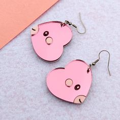 The heart fish pocket monster. They are pink and and pastel with black eyes, and engraved details. Earrings are a pair. Brooches are available and sold as 1 piece. Hardware is silver-toned (add a note at checkout if you prefer gold-toned). Dimensions: Dangle Earrings: 1.5 in (38 mm) L x 1.4 in (35 mm) W        The drop length is about 2.0 in (51 mm). Brooch: 2.4 in (60 mm) L x 2.2 in (56 mm) W Materials: Mirror Acrylic Hypoallergenic, Nickel Free, Stainless Steel Shipping: All of our earrings are made-to-order to cut down on waste. Your earrings will be produced and shipped within a week after you order. Care: Do not soak earrings in water. Materials are water resistant, but it is not recommended that you swim, shower, or bath with your earrings on. Avoid getting lotions, oils, and perfume Kawaii Heart Earrings For Valentine's Day, Cute Pink Pierced Heart Earrings, Cute Pink Heart Pierced Earrings, Valentine's Day Kawaii Heart Earrings, Pink Kawaii Heart Earrings For Valentine's Day, Pink Kawaii Earrings For Valentine's Day, Kawaii Pink Earrings For Valentine's Day, Valentine's Day Pink Kawaii Earrings, Valentine's Day Kawaii Pink Earrings