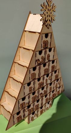 a wooden pyramid with numbers and snowflakes on top