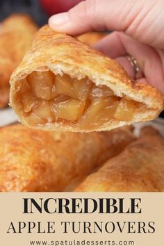 an apple turnover is being held up to show the inside