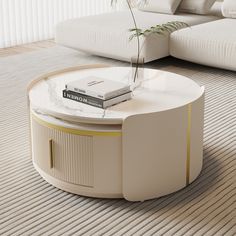 a white coffee table with a book on it and a plant in the centerpiece