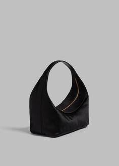 Color: Black Smooth satin Structured shape Single strap Interior zip-up pouch Top zip closure 72% Viscose 28% Silk By Loulou Studio. Imported Evening Bags With Zipper Pocket, Luxury Evening Hobo Pouch Bag, Luxury Evening Bags With Zipper Pocket, Evening Clutch Shoulder Bag With Zipper, Evening Clutch With Zipper Closure, Luxury Evening Shoulder Bag With Zipper Closure, Evening Hobo Shoulder Bag With Zipper, Versatile Evening Shoulder Bag With Zipper, Versatile Evening Shoulder Bag With Zipper Closure