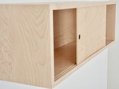 a wooden shelf with two open compartments on it