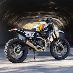 a dirt bike parked in front of a tunnel