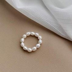 Freshwater Pearl White Artisan Bead Ring Color: White Size: Free Size Ring Weight: 6g Stone Color: White Stone: Freshwater Pearl, Pearl White Beaded Pearl Ring, White Pearl Rings With Round Beads, White Pearl Ring For Jewelry Making, Handmade Minimalist White Pearl Ring, Minimalist Handmade White Pearl Ring, White Pearl Ring With Round Beads For Wedding, Dainty White Pearl Ring With Round Beads, Dainty White Pearl Ring, Minimalist White Beaded Rings