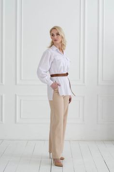 Introducing our Pantschny kit, a stylish and unique ensemble that combines comfort with sophistication. This kit includes an open-cut shirt and pants that are both crafted from high-quality materials and designed with attention to detail. The shirt features a stand-up collar and a dropped shoulder line, creating a relaxed yet stylish silhouette. The sleeves are designed with cuffs that add a touch of sophistication to the design. The shirt is also equipped with a patch pocket on the chest, providing a practical touch that allows you to keep essentials close at hand. The fastener on the front of the shirt is comprised of buttons, creating a polished and refined look. This fastener makes it easy to put on and take off the shirt, adding a touch of convenience to the design. The pants in this Shirt Set Outfit, Outfit For Office, Office Suit, Suit Shirt, Womens Suits, Office Set, Set Outfit, Cut Shirts, Shirt And Pants