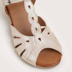 This vintage sandal reminds us of a bygone era. Feminine t-straps with cutout details adorn this beautiful sandal. A padded footbed adds modern-day comfort and wearability. Genuine leather uppers Cutout T-Strap design Padded insole for comfort 1 1/2" rubber heel and sole Style Name: BERGEN-GLD