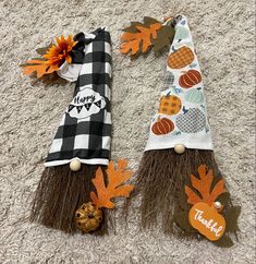 two scarecrows made out of burlocks and pumpkins are sitting on the carpet