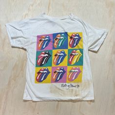 "D E T A I L S *  VTG 1989 Rolling Stones Steel Wheels tour t-shirt * Vibrant front graphic * Made in Canada * Single Stitch  S P E C I F I C S Label:  Brockum  Tag Size: Large Fits Like: Medium Colour: White Material: Cotton Condition: Great Vintage Condition! Big stain on lower front of the shirt, hole in both armpits. Shown in pictures M E A S U R E M E N T S  pit to pit: 20\"  length: 25\" Please refer to our sizing guide if you require additional sizing information. www.etsy.com/shop/MintageClothingCo/policy ✭ visit the rest of the shop ✭ www.etsy.com/shop/MintageClothingCo INSTAGRAM: Mintage FACEBOOK: MintageClothingCo TWITTER: MintageClothing" 90s Style White Graphic Print T-shirt, Vintage Multicolor Screen Print T-shirt, Retro Multicolor Screen Print T-shirt, 90s White Graphic Print T-shirt, 90s Style White Tops With Vintage Print, Multicolor Vintage Print T-shirt, Vintage White T-shirt With Screen Print, Retro White T-shirt With Vintage Print, 90s White Fan Merchandise T-shirt