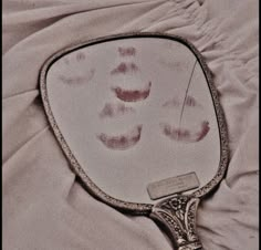 a close up of a mirror on a bed