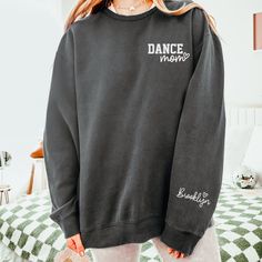 "Custom Dance Mom Sweatshirt with Dancer(s) Name on Sleeve, Trendy Dance Mom Crewneck, Dance Mom Personalized Comfort Colors Sweatshirt Gift How To Order - Please make sure you have looked at all sizes and color charts. - Select from the various T-shirt sizes and colors from scroll-down menus. - Fill in the personalization box (if provided) as exemplified. - Click \"Add to cart\" button. You can turn back and add more items of different size and color. Order Process - Our processing time is 5-10 Custom Crewneck Sweatshirts, Mom Crewneck, S Name, Dance Mom, Comfort Colors Sweatshirt, Mom Sweatshirt, Color Charts, Dance Moms, Comfort Colors