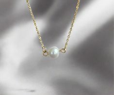 Enhance your feminine grace with our Single Pearl Necklace. Made with a dainty, cute design, this necklace will add a touch of girly elegance to any outfit. Stand out and make a statement with this unique and sophisticated accessory. 15 inches long + 2 inches ext 18K PVD gold plated stainless steel Fresh Water Pearl Pendant Non Tarnish And Water Resistant Elegant Yellow Gold Hypoallergenic Charm Necklace, Elegant Hypoallergenic Yellow Gold Charm Necklace, Elegant Hypoallergenic Round Pendant Necklace, Elegant Hypoallergenic Rose Gold Charm Necklaces, Elegant Rose Gold Hypoallergenic Charm Necklaces, Elegant Hypoallergenic Rose Gold Charm Necklace, Elegant Gold Hypoallergenic Charm Necklace, Elegant Hypoallergenic Pendant Necklaces, Elegant Hypoallergenic Pendant Necklace