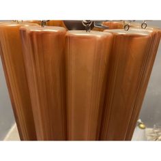 a tall brown vase sitting on top of a table