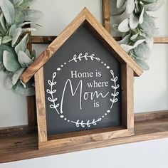 a house shaped chalkboard with the words home is where mom is