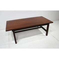 a wooden table sitting on top of a white floor