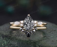 an engagement ring set with a pear shaped diamond and two smaller pear shaped diamonds on top