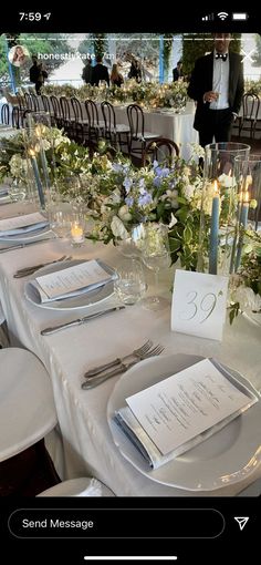 the table is set with silverware and place settings for guests to sit down at