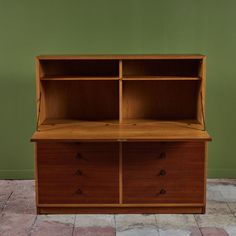 a wooden cabinet with two drawers on one side and an open shelf on the other