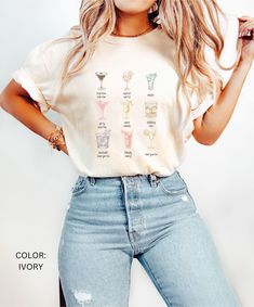 a woman in ripped jeans and a t - shirt with the names of wine glasses on it