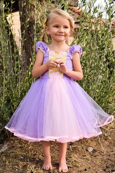 "RAPUNZEL costume, Rapunzel dress, Rapunzel TUTU dress, Lavender dress SIZES- 6/12m, 18/24, 2/3T, 4/5T, 6/6x 7/8 and 10/12 READY TO SHIP This Rapunzel dress is a must for your princess party. This is the TUTU dress version of my sweetheart dress. This dress is made of a soft cotton poly blend fabric. The skirt is layered with purple colored tulle with a pink strip in the center of the front skirt. The front has a sweetheart neckline with pink inset. The inset is trimmed with gold metallic ribbon Lavender Fitted Princess Dress For Dress-up, Pink Princesscore Dress For Halloween, Lavender Princess Dress For Dress-up, Princess Costume With Ruffles For Fancy Dress, Purple Ruffled Princess Dress For Dress-up, Lavender Princess Dress For Dress-up Occasions, Pink Princess Fairy Dress For Costume Party, Princess Tulle Costume For Dress-up, Princess Style Tulle Costume For Dress-up