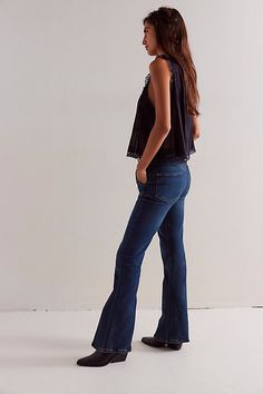 So sleek with Western-inspired flair, these jeans from our We The Free collection will turn heads with every wear. **Fit:** Mid-rise, slim flare fit **Features:** Zip fly and button closure, four-pocket design, flattering seaming throughout, soft stretch denim **Why We ❤ It:** Classic with pointed boots or off-duty with sneakers, this pair has endless ways to wear. | We The Free Ashland Flare Jeans at Free People in Dark Wash, Size: 28 Pointed Boots, Metropolis, Off Duty, Pocket Design, Jeans Shop, Boho Outfits, Flare Jeans, Stretch Denim, Mid Rise