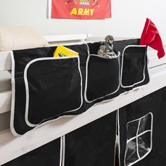 a black and white bunk bed with two storage bins on the bottom, and a red army flag hanging above it