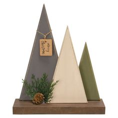 three triangular wooden ornaments with pine cones on top