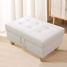 a white ottoman sitting on top of a carpeted floor