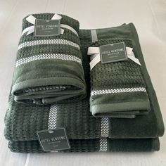 towels folded up on top of each other with tags attached to the handles and sides