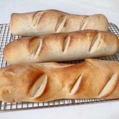 two loaves of bread sitting on top of a cooling rack