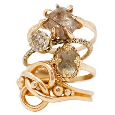 an assortment of rings with different shapes and sizes on them, all in gold plated metal