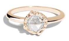 a gold ring with an oval cut diamond