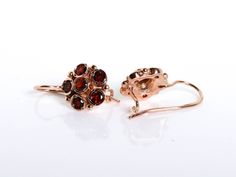 These 14K Rose gold Garnet earrings are handcrafted in a dainty floral design. One red garnet is in the middle, encircled by five garnet tones, creating a delicate flower. The rose gold blends in with the red garnet. Details and Measurements: ► 14 Karat Rose Gold ► Total Weight 4.19 gr ► 12 Garnet stones 4 mm All items are Handmade, I pay a lot of attention for every detail in the jewelry I design. All of my items are hand crafted in Kisufim's Designer jewelry Store in Tel Aviv, and shipped dire Elegant Cluster Gemstone Earrings, Fine Jewelry Cluster Earrings As Gift, Luxury Wedding Earrings With Lever Back Ear Wires, Cluster Yellow Gold Earrings For Gifts, Jewelry Rose Gold, Anniversary Gift For Wife, Garnet Earrings, Anniversary Gifts For Wife, Garnet Stone